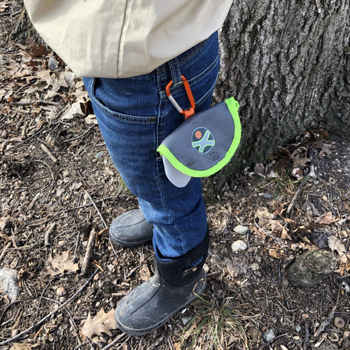 Terra Kids | Binoculars & Bag hanging from a child's jeans outdoors ready for an exploration adventure.