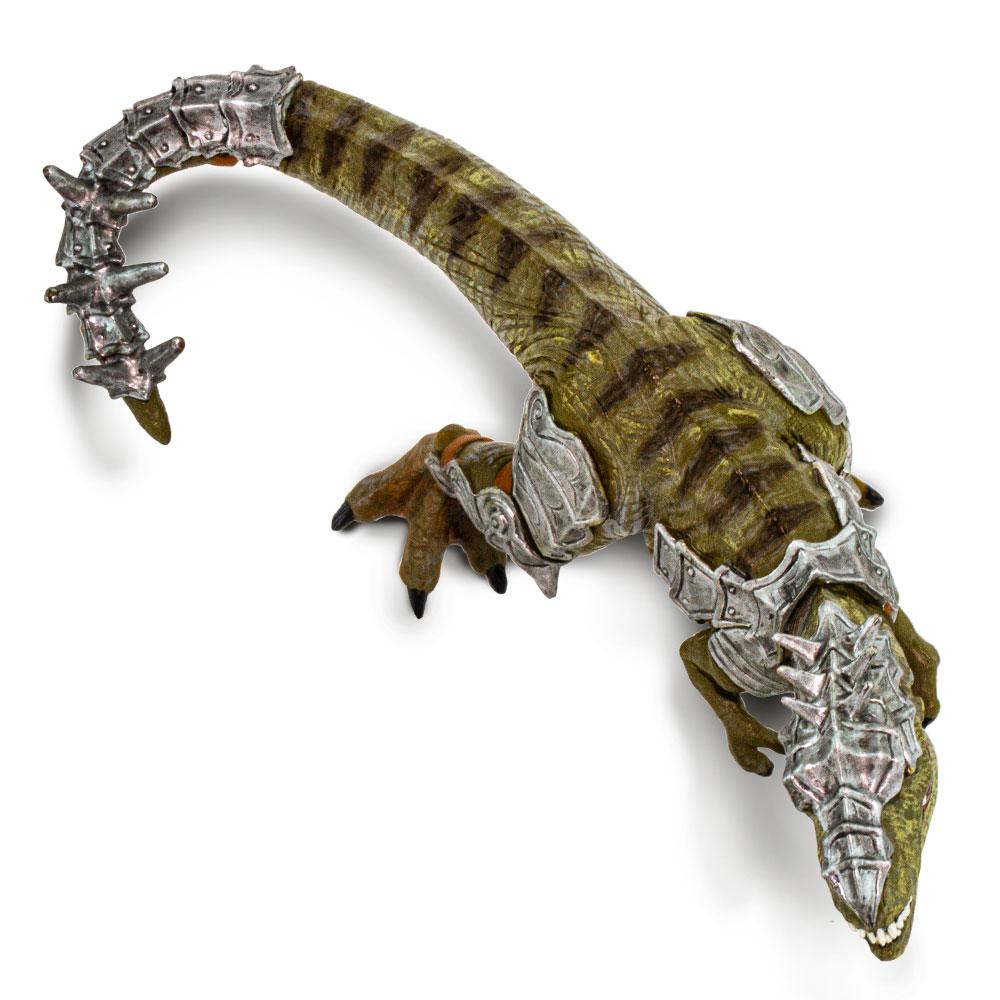 Armored T-Rex toy with green and brown stripes, silver spiked armor, and movable jaw, measuring over 6 inches long.