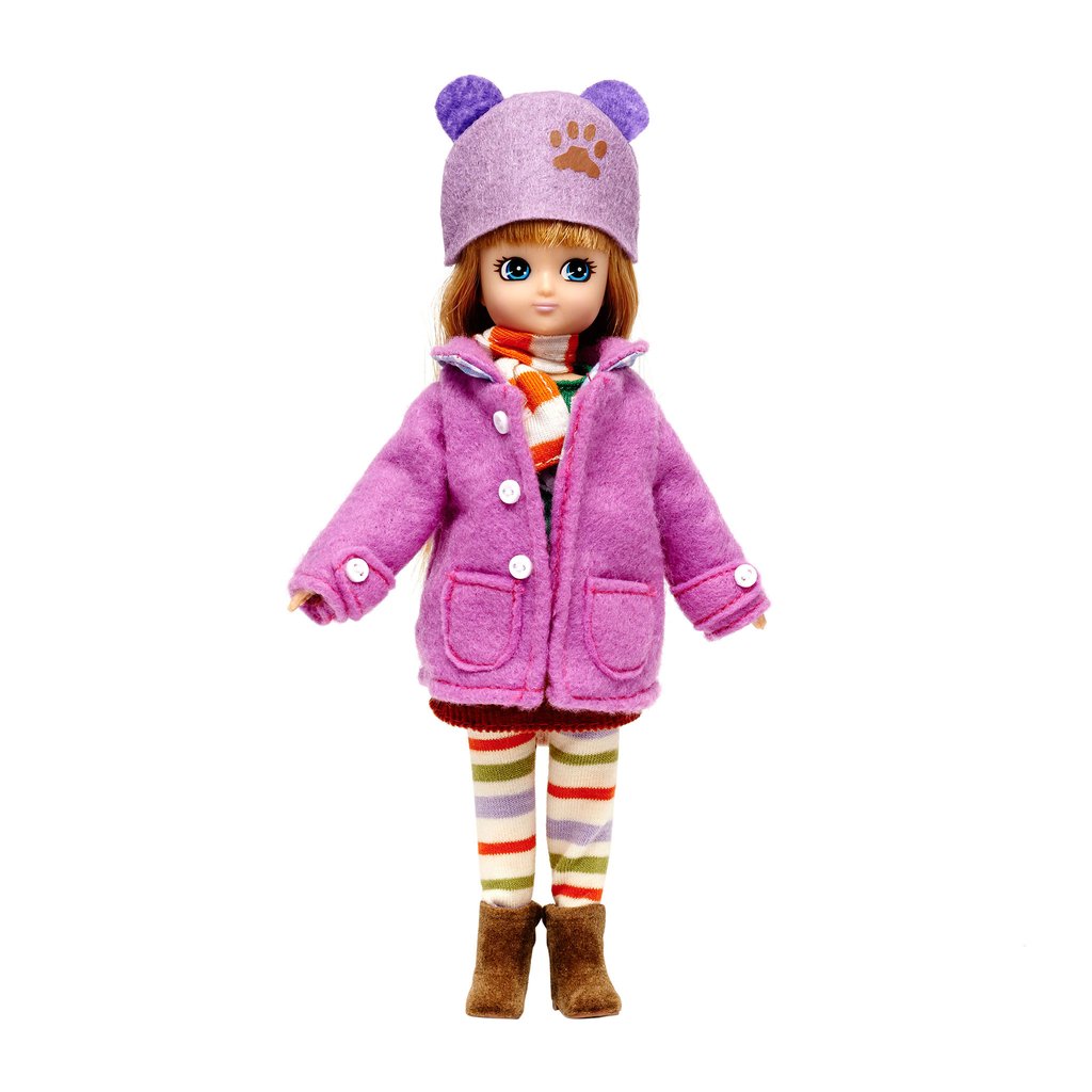 Lottie Autumn Doll wearing purple coat, hat with ears, striped leggings, scarf, and boots standing on white background.