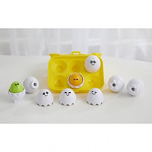 Peek 'n Peep Eggs toy with colorful chicks inside eggshells and a yellow carton for shape sorting and play.