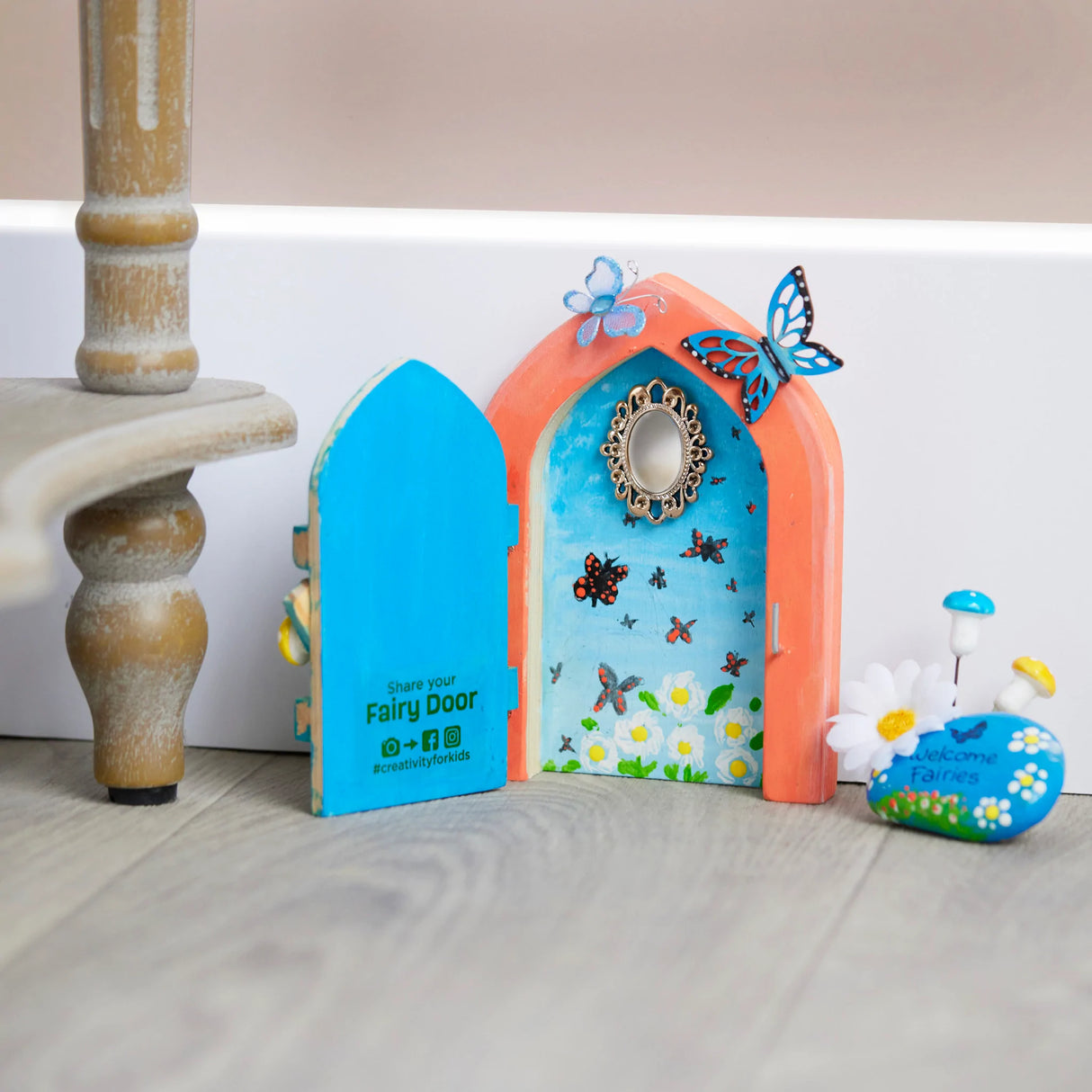 Butterfly Fairy Door craft kit with painted wooden door, butterfly accents, mirror, and miniature fairy decorations.