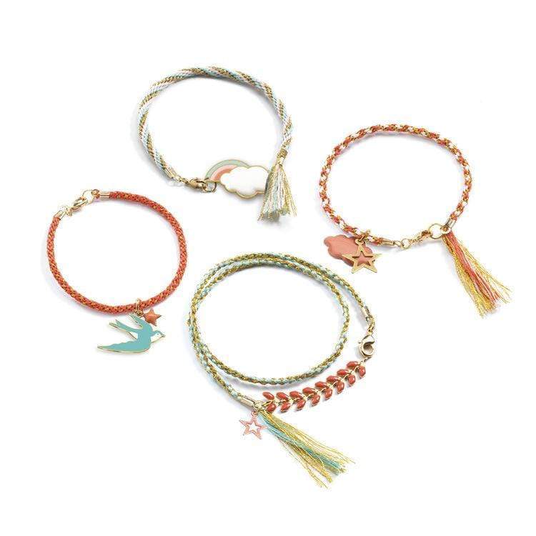 Celeste Beads Set featuring four unique, colorful handmade bracelets with charms and tassels on a white background.