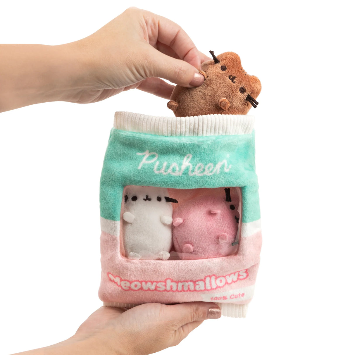 Hands holding Pusheen Meowshmallows plush bag with three removable miniature Pusheen plush toys inside