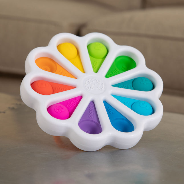 Dimpl Digits colorful silicone bubble toy with numbers and words embossed for tactile learning and fine motor skill development.