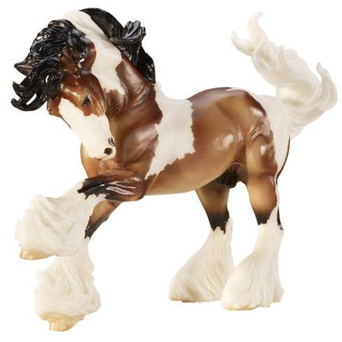 Gypsy Vanner model horse with lush mane, tail, feathered legs, and piebald brown and white coat.
