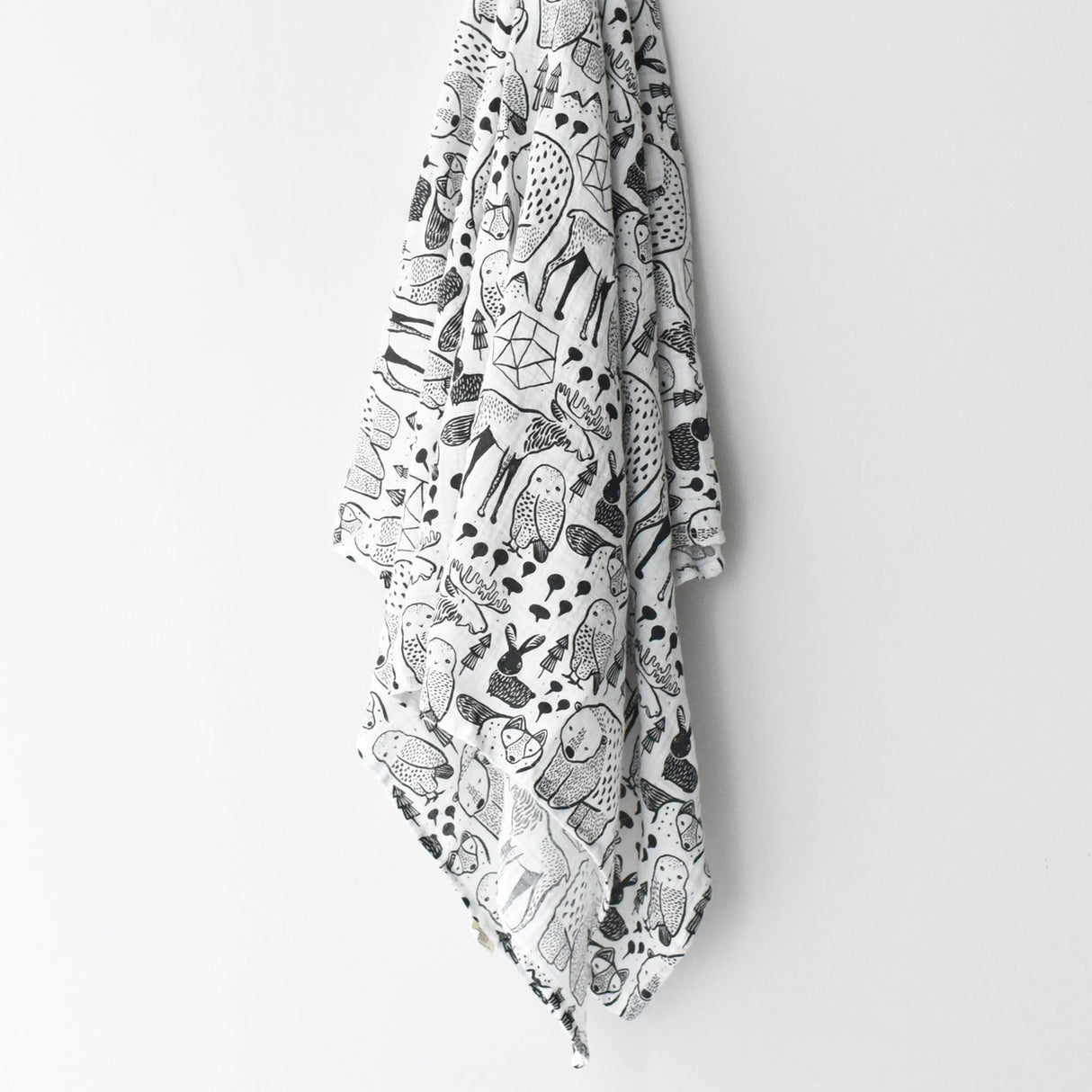 Organic Muslin Swaddle | Nordic hanging with black and white animal illustrations on soft organic cotton muslin fabric.