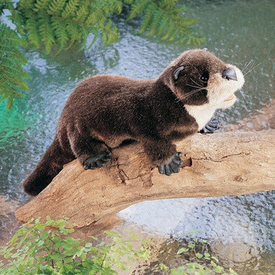 River Otter Puppet with chestnut fur and detailed webbed feet perched on a log over a stream.
