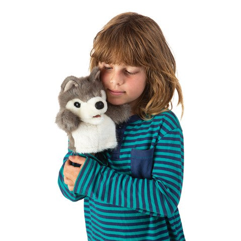 Child playing with the Wolf Little Hand Puppet, a soft wolf puppet perfect for imaginative play and storytelling.