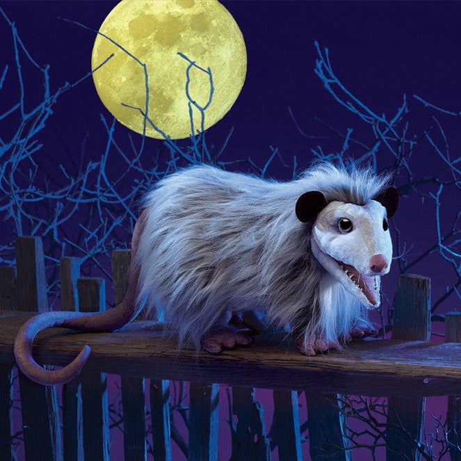 Opossum Puppet with realistic fur and rat-like tail on wooden fence under full moon at night.