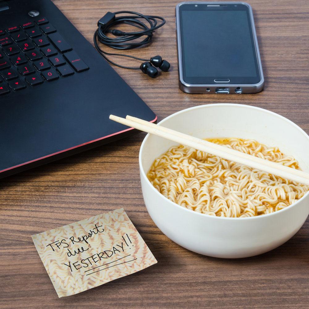 Ramen Notes sticky note with reminder next to ramen bowl, laptop, and phone on wooden table for quick memos.