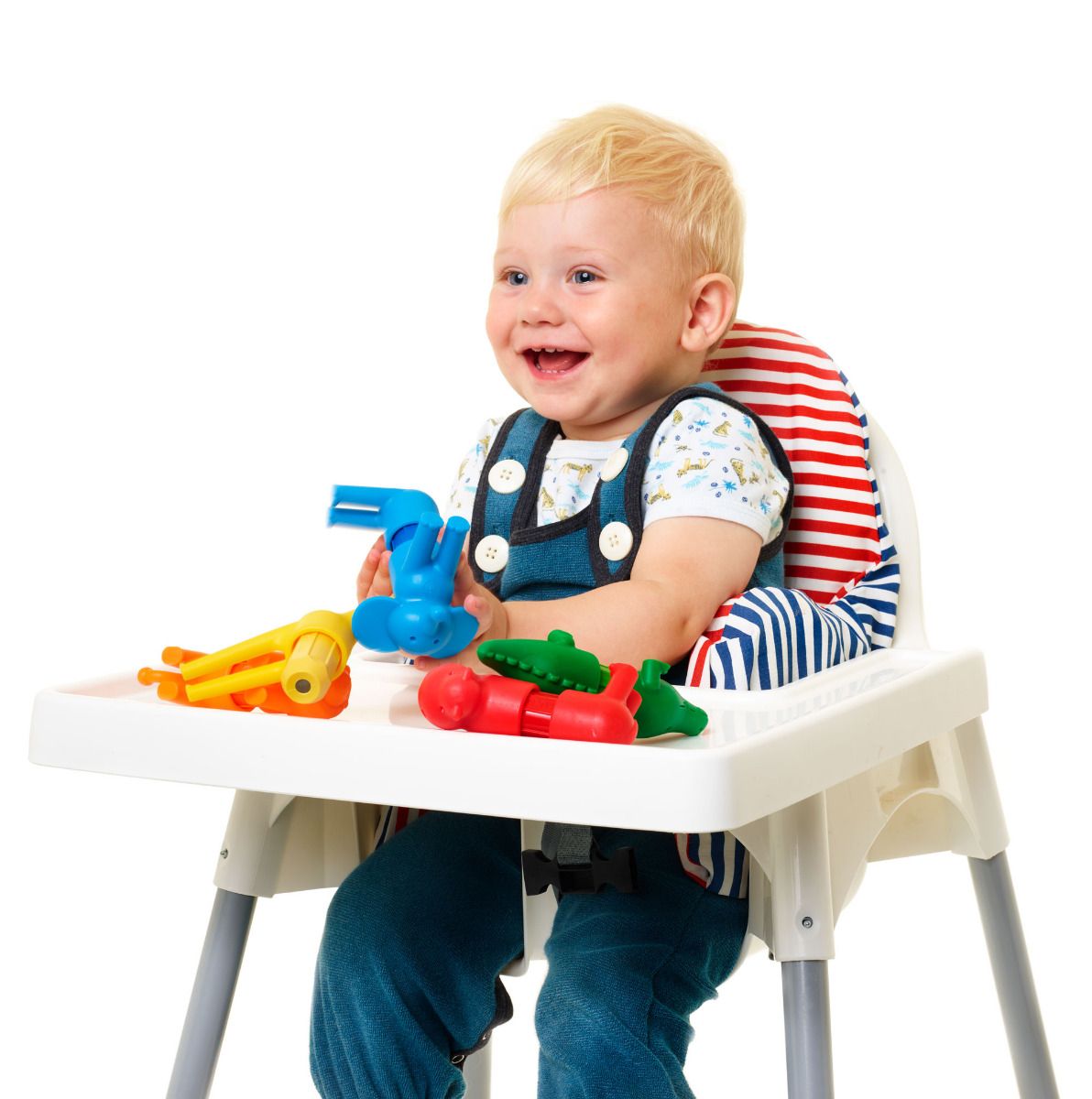 Baby playing with colorful animal pieces from Smartmax My First Safari Animals set on high chair tray