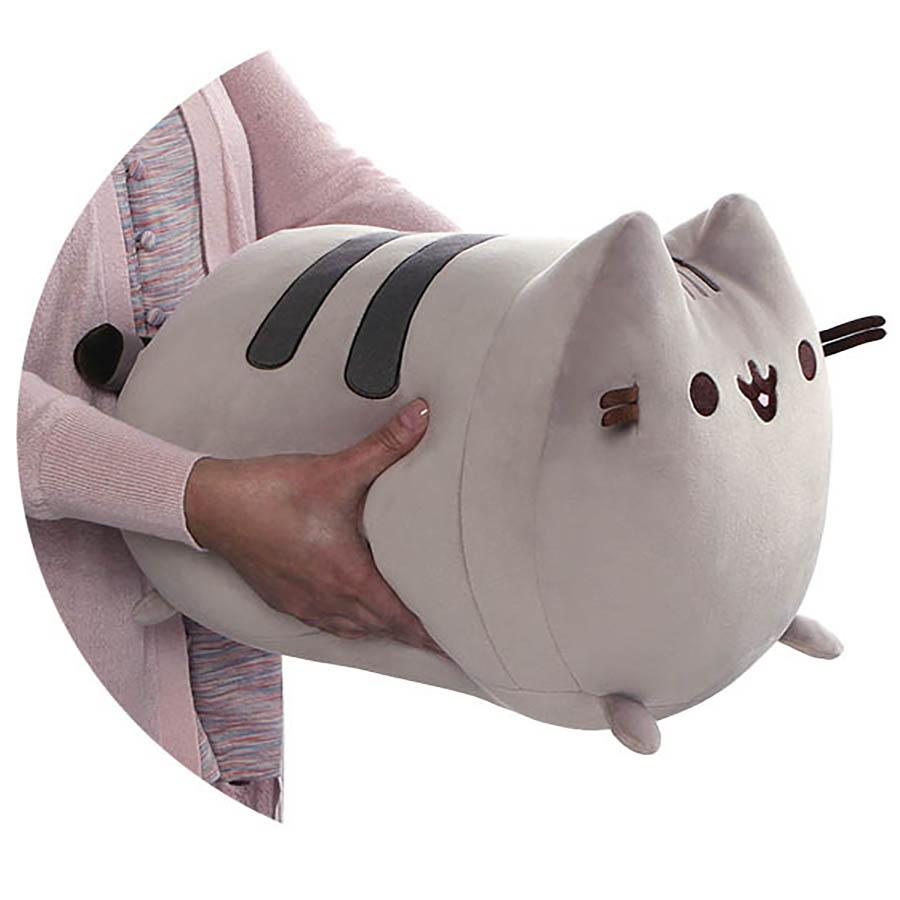 Person holding a soft and squishy 11” Pusheen Squisheen Log plush with signature smile and gray stripes.