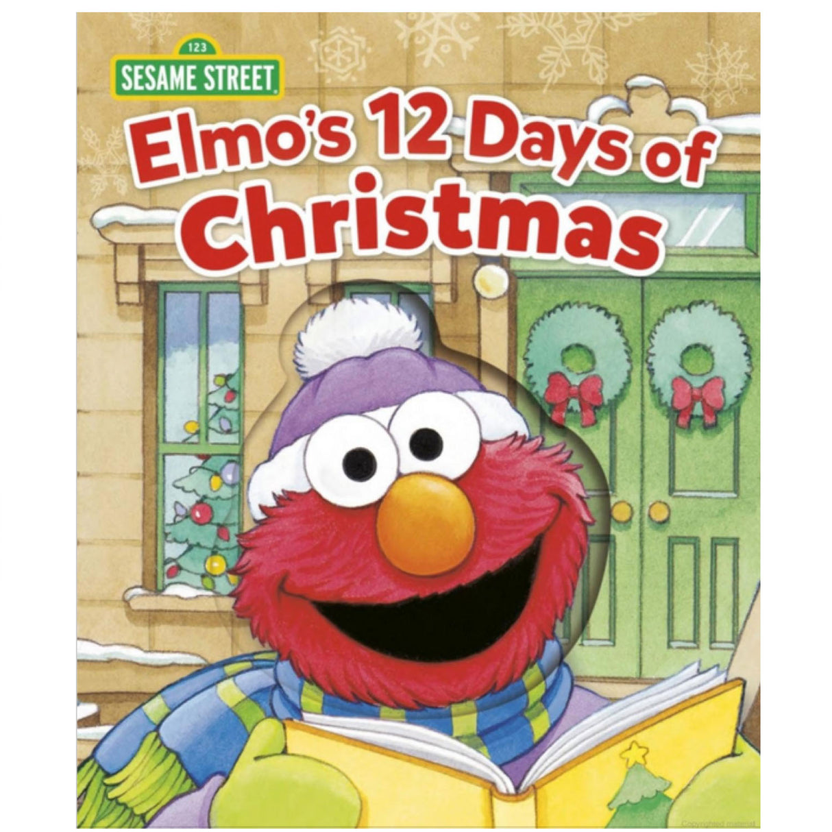 Elmo wearing winter clothes holding a book titled Elmo's 12 Days of Christmas with holiday decorations in the background