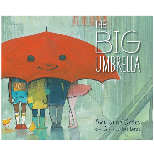 Cover of The Big Umbrella book showing diverse children smiling under a large red umbrella on a rainy day.