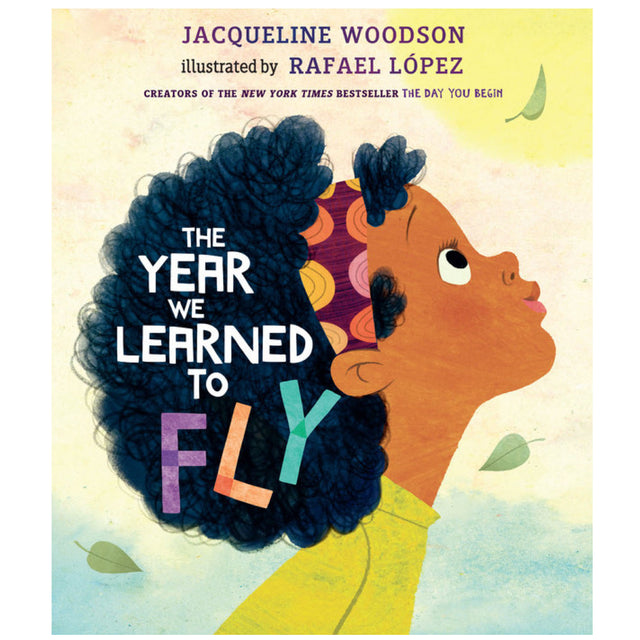 Cover of The Year We Learned to Fly showing a girl with curly hair looking up surrounded by falling leaves.