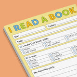 Colorful kids’ reading journal pad with spaces to fill in book details, companions, and favorite parts on a yellow background.