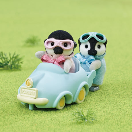 Penguin Babies Ride features twin penguin figures Pearl and Rocky in pink and blue with goggles and blue pushcart vehicle.