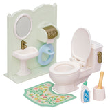 Toy bathroom set with sink, mirror, toilet, bath mat, soap bottle, and brush