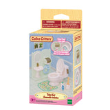 Illustrated package showing a miniature bathroom scene with a toilet, sink, bathtub, mirror, and accessories