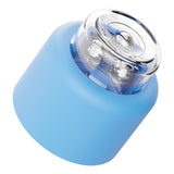 Small blue rounded device with a transparent top showing internal metallic rotating balls