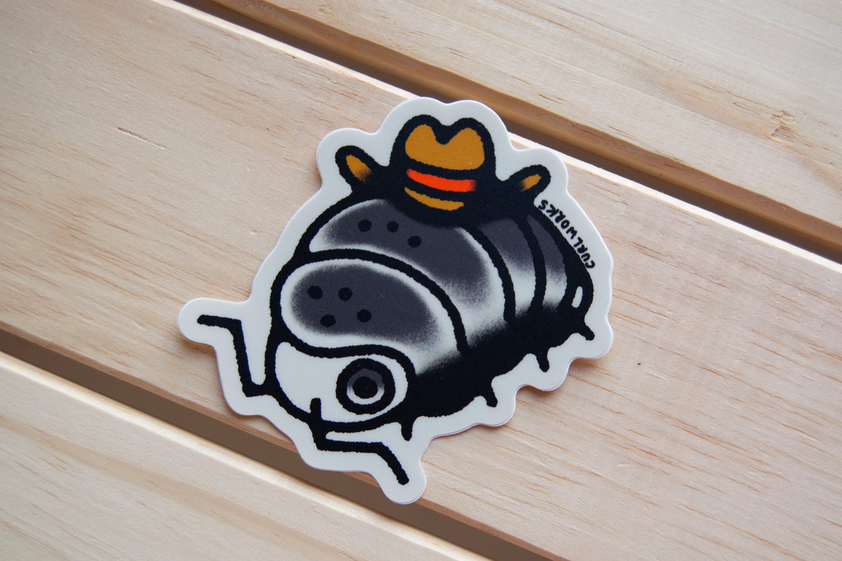 Colorful 3-inch vinyl sticker of a bug wearing a cowboy hat on a wooden surface, weatherproof and semi-matte finish