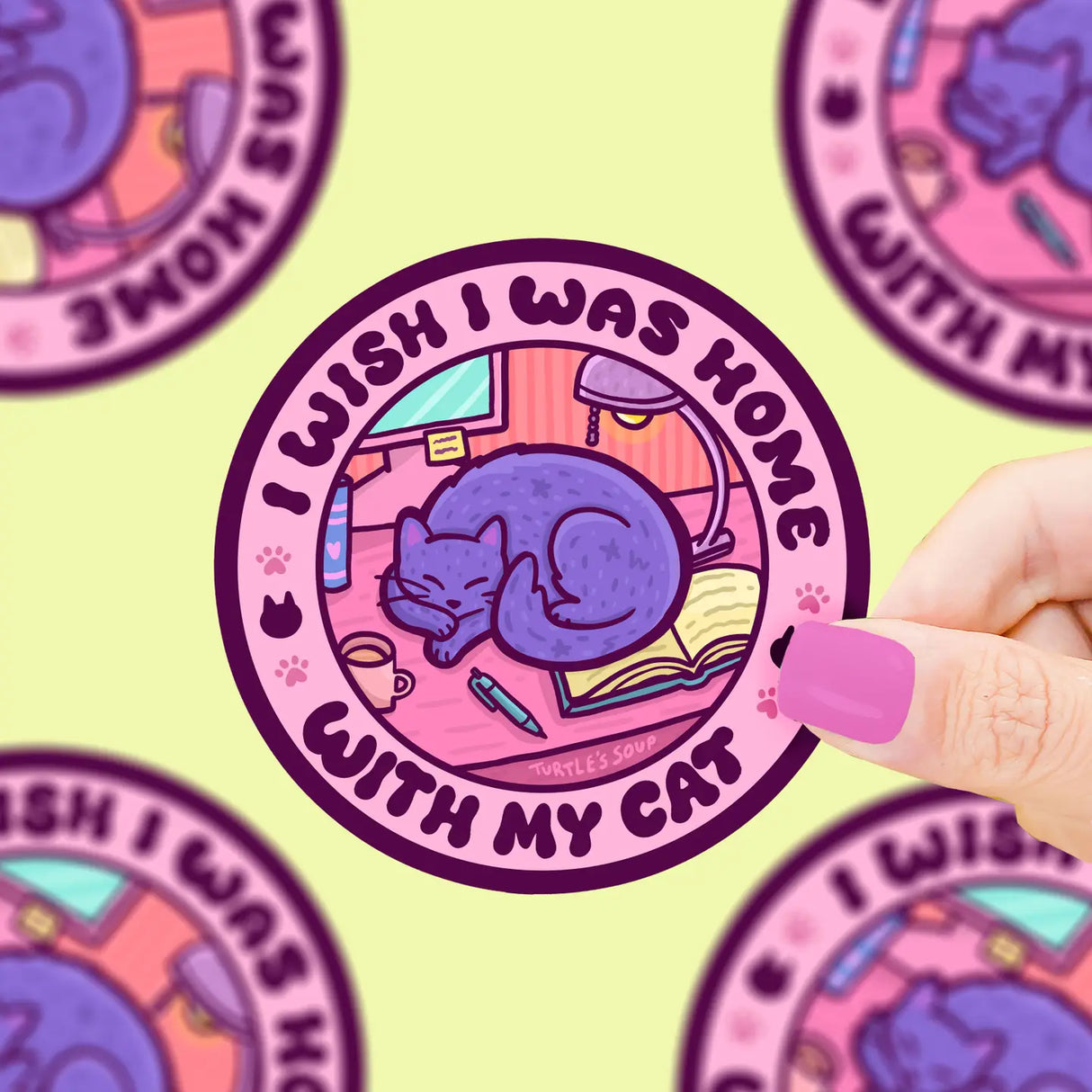 I Wish I was Home Sticker" showing a purple cat curled up on a desk with book and pen, durable vinyl design.