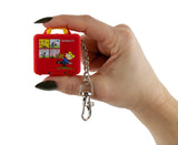 World's Smallest Peanuts Lunch Box tiny red lunch box keychain held in hand