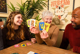 Pounce game with friends holding colorful letter cards during a lively tabletop game