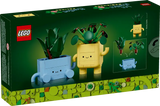 LEGO Botanicals Happy Plants set featuring a baby dracaena and pilea plant with cheerful blue and yellow pots.
