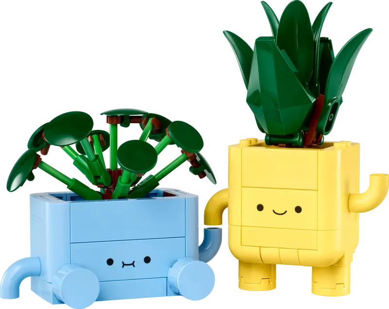 Botanicals Happy Plants building set with baby dracaena in yellow pot and baby pilea in blue pot with smiling faces.