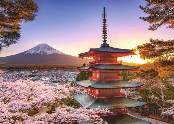 Traditional red Japanese pagoda surrounded by cherry blossoms with Mount Fuji in the glowing sunset background
