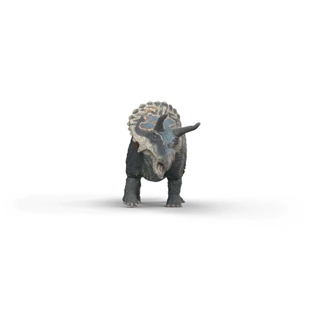 Triceratops toy dinosaur standing on a white background