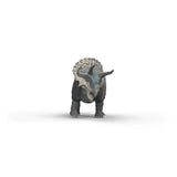 Triceratops toy dinosaur standing on a white background