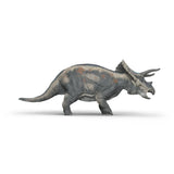 Triceratops dinosaur figure with textured gray skin and distinctive horns standing on a white background