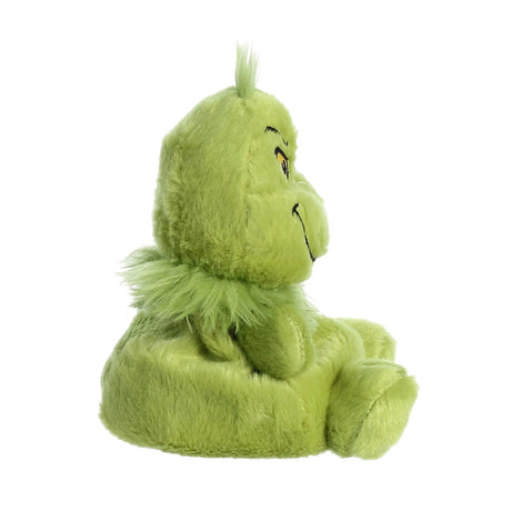 Side view of a soft 5-inch green plush character with a mischievous grin and tuft of hair on top