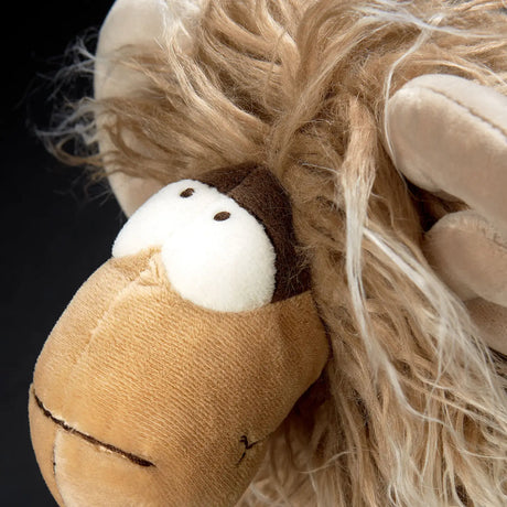 Close-up of plush toy face with fluffy hair and large eyes, showcasing the Mufflon Muff product for children 12+.