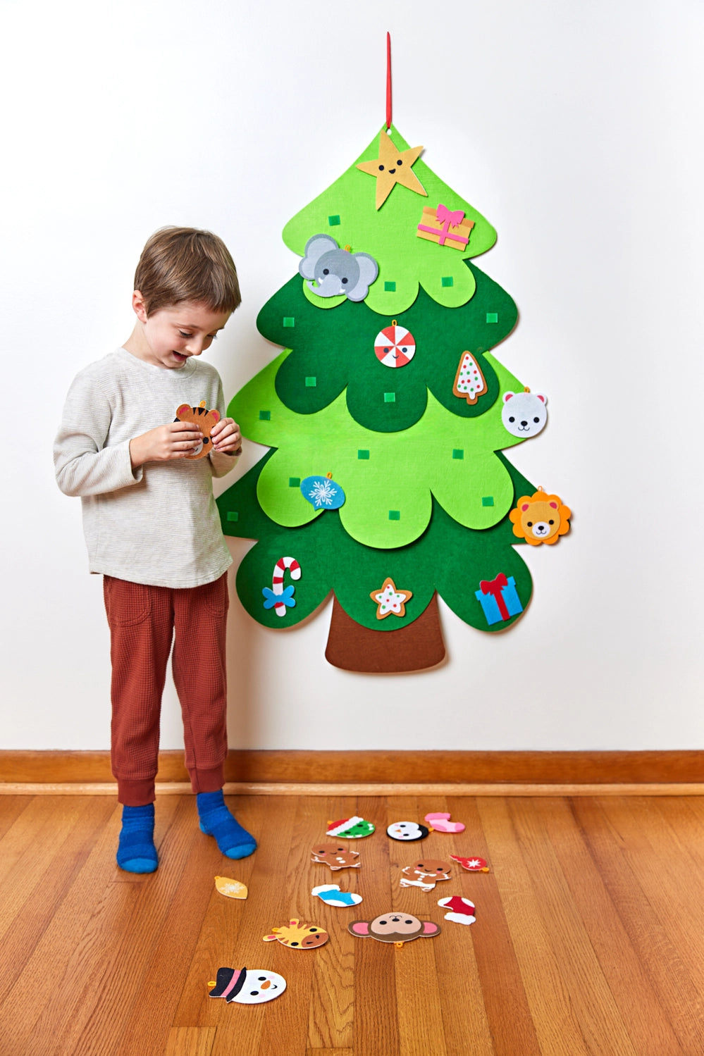 Decorate Your Own Christmas Tree with a child adding colorful ornaments