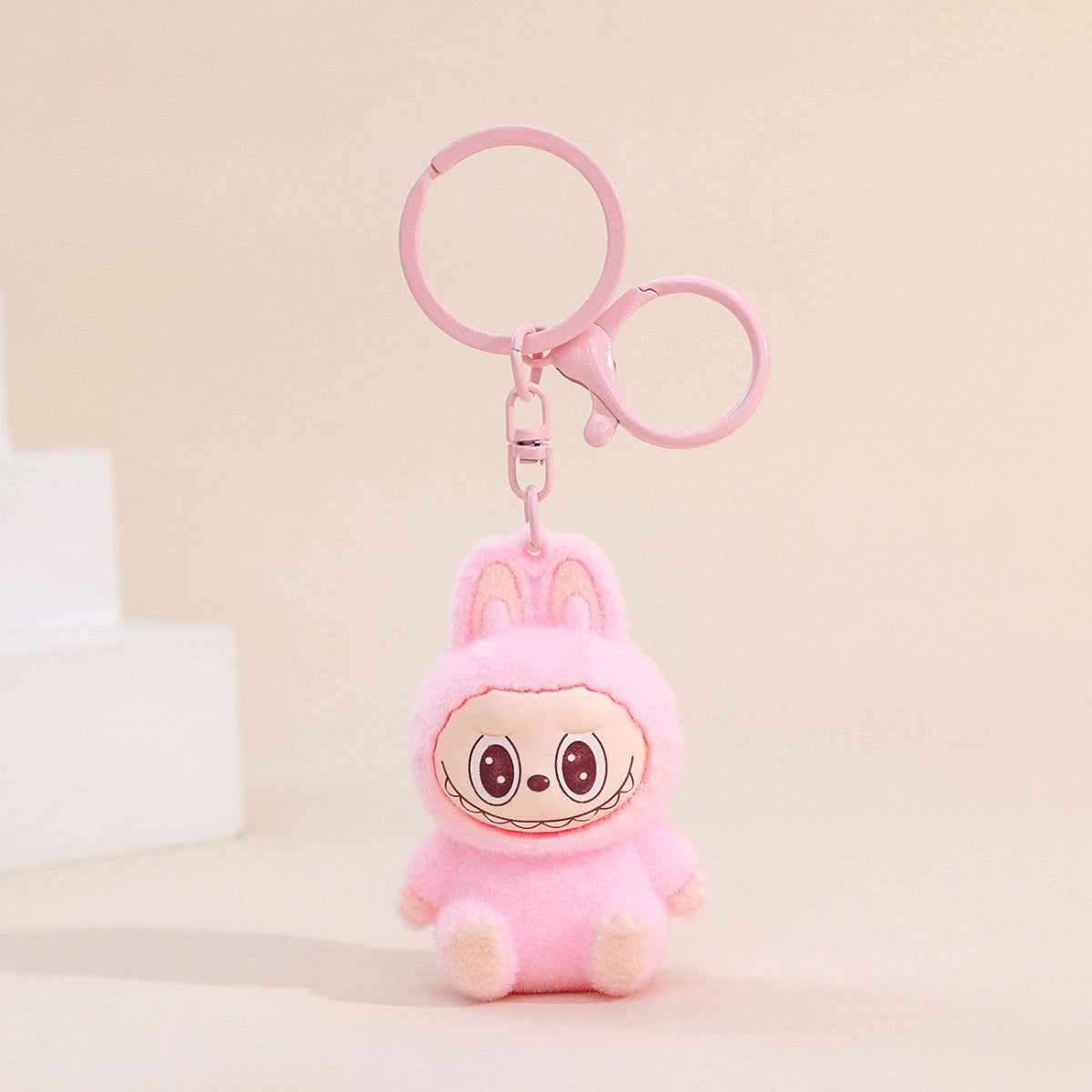 Labubu Flocking Keychain in pink with fuzzy texture and silly smile, perfect for cheerful and stylish keys.