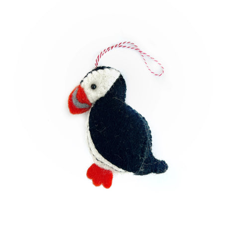 Handmade puffin felt ornament in black, white, and orange wool with hanging string, perfect for holiday decor.