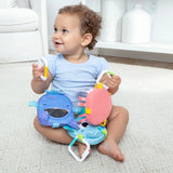 Ocean Waves Bounce Back Links colorful sensory toy with a happy toddler playing on the floor