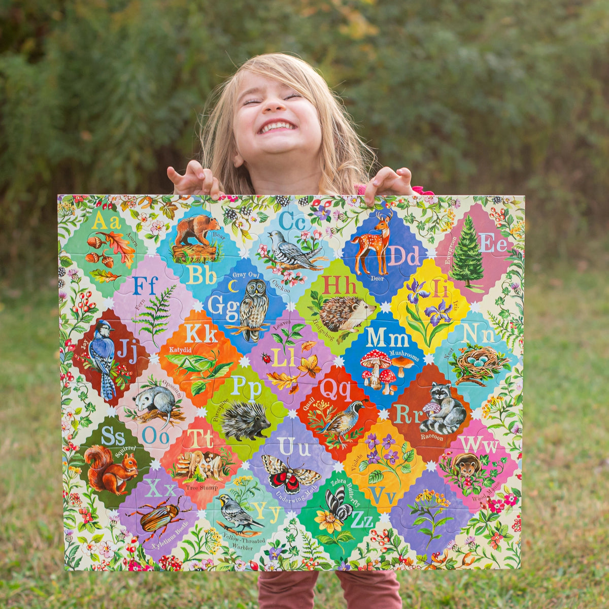 36pc A is for Acorn Giant Puzzle with colorful alphabet artwork held by a smiling child
