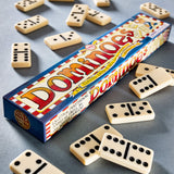 Classic dominoes set with black dots scattered around colorful rectangular box on gray surface