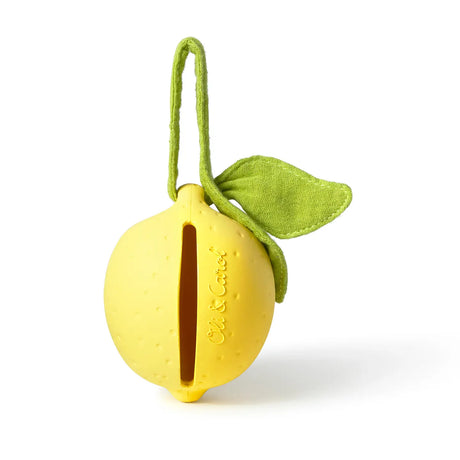 Yellow lemon-shaped pacifier case with green fabric leaf and loop made from natural rubber and organic cotton