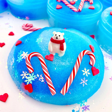 Arctic Icee Cola Soda Jelly Slime with blue icy texture, polar bear charm, candy canes, and heart decorations.