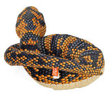 Soft snake plush toy with black and orange diamond scales curled up in resting position