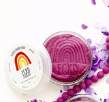 KidDough Glitter | Purple shown open with smooth, pliable purple dough and glittery decorations nearby.