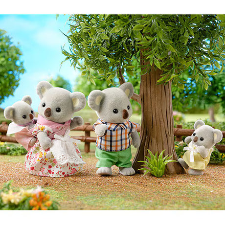 Koala Family plush koala toys gathered beneath a tree in a cheerful outdoor scene