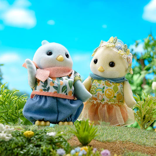 Citrus Bird Family plush bird characters in colorful outfits in a sunny garden