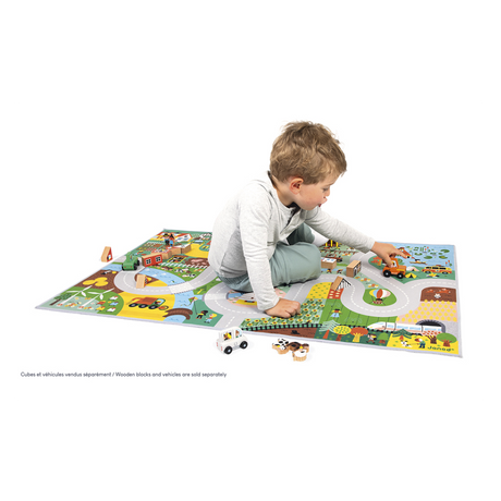 Child playing on Crossroads Countryside Play Mat featuring roads, farm, forest, animals, and buildings for imaginative play.