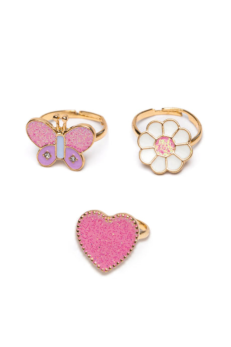 Wonderland Ring Set featuring pink glitter heart, white flower, and pink butterfly adjustable rings on gold bands.